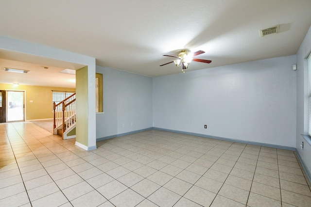 15522 Noble Brook Ct, Houston, TX 77049 - unfurnished room featuring ceiling fan, stairs, light tile patterned floors, and baseboards
