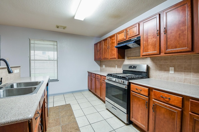 15522 Noble Brook Ct, Houston, TX 77049 - kitchen with gas range, under cabinet range hood, a sink, light countertops, and a textured ceiling