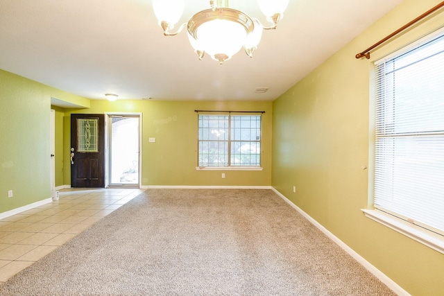 15522 Noble Brook Ct, Houston, TX 77049 - empty room with a chandelier, plenty of natural light, light tile patterned floors, and light colored carpet
