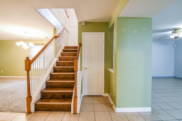 15522 Noble Brook Ct, Houston, TX 77049 - staircase featuring a chandelier, tile patterned floors, ceiling fan, and baseboards