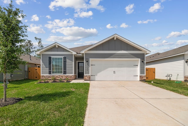 15854 Berry Hill Dr, Conroe, TX 77303 - single story home with a gate, stone siding, a garage, driveway, and board and batten siding