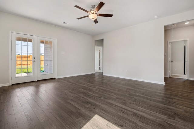 15854 Berry Hill Dr, Conroe, TX 77303 - unfurnished living room with attic access, a ceiling fan, dark wood-type flooring, and baseboards