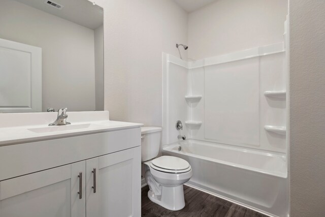 15854 Berry Hill Dr, Conroe, TX 77303 - full bathroom featuring wood finished floors, toilet, vanity, and bathtub / shower combination