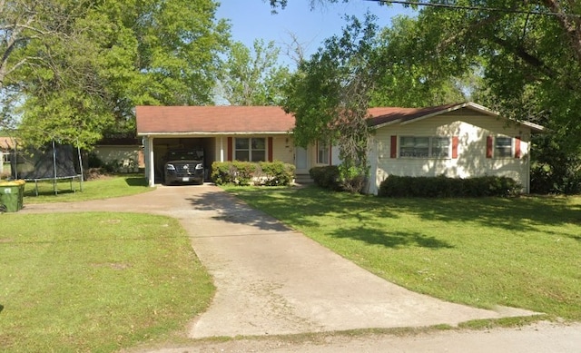601 S Ellis St, Groesbeck, TX 76642 - single story home featuring a trampoline, concrete driveway, a front lawn, and an attached carport