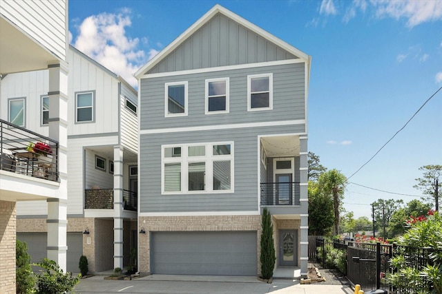 622 Janisch Rd Unit A, Houston, TX 77018 - view of front of home featuring board and batten siding, a garage, fence, driveway, and brick siding