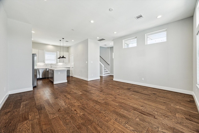 622 Janisch Rd Unit A, Houston, TX 77018 - unfurnished living room featuring dark wood-style flooring, baseboards, stairway, and recessed lighting