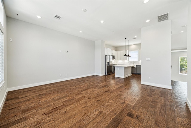 622 Janisch Rd Unit A, Houston, TX 77018 - unfurnished living room featuring dark wood-type flooring, recessed lighting, and baseboards