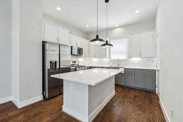 622 Janisch Rd Unit A, Houston, TX 77018 - kitchen with appliances with stainless steel finishes, tasteful backsplash, dark wood-style flooring, a center island, and white cabinetry