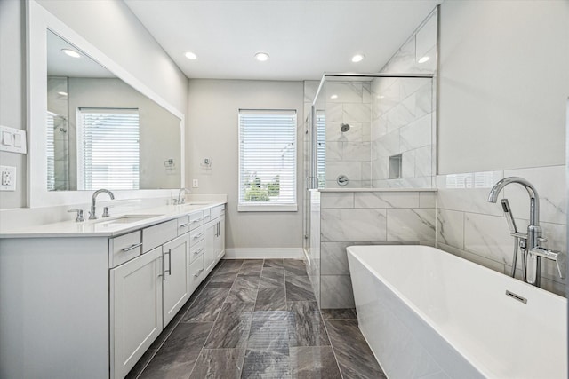 622 Janisch Rd Unit A, Houston, TX 77018 - bathroom with marble tiled floors, plenty of natural light, a shower stall, double vanity, and recessed lighting