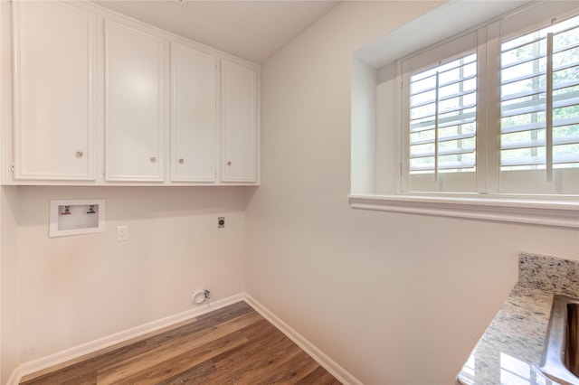 clothes washing area featuring electric dryer hookup, cabinet space, wood finished floors, baseboards, and hookup for a washing machine