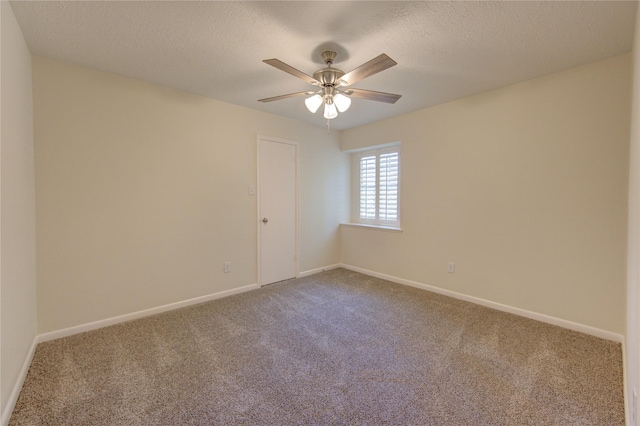 carpeted empty room featuring ceiling fan, baseboards, and a textured ceiling