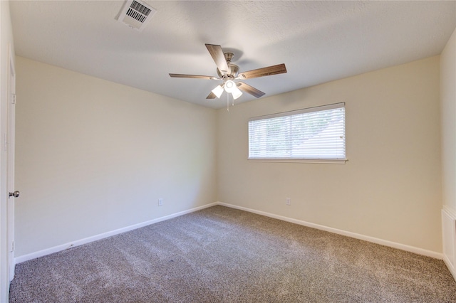 carpeted empty room featuring a ceiling fan and baseboards