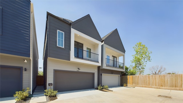 3019 Jensen Springs Ln, Houston, TX 77026 - view of front of house featuring fence, a balcony, an attached garage, and driveway