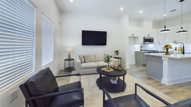 3019 Jensen Springs Ln, Houston, TX 77026 - living area with light wood-style floors, recessed lighting, and baseboards