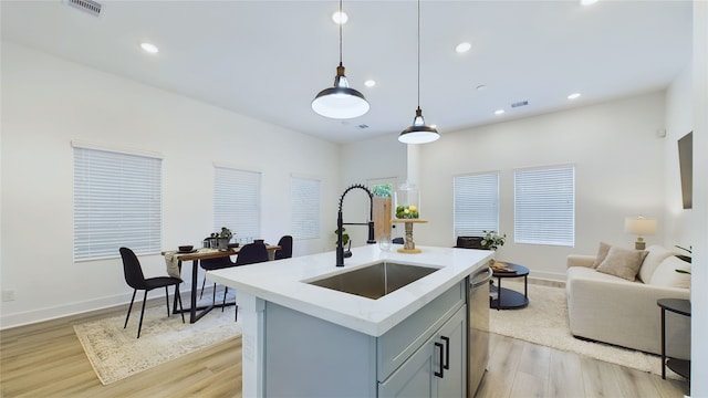 3019 Jensen Springs Ln, Houston, TX 77026 - kitchen featuring a sink, light wood-style floors, dishwasher, hanging light fixtures, and recessed lighting