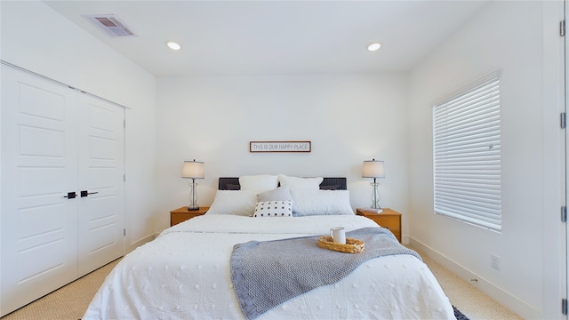 3019 Jensen Springs Ln, Houston, TX 77026 - bedroom with light carpet, baseboards, a closet, and recessed lighting