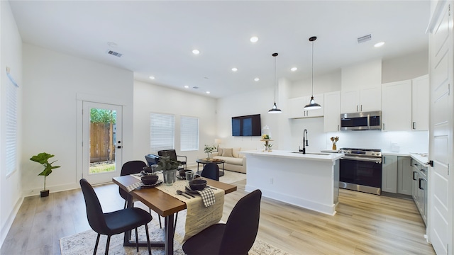3019 Jensen Springs Ln, Houston, TX 77026 - dining space with light wood-style flooring, recessed lighting, baseboards, and a high ceiling