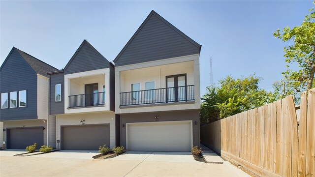 3019 Jensen Springs Ln, Houston, TX 77026 - view of property with fence, a garage, a balcony, and driveway