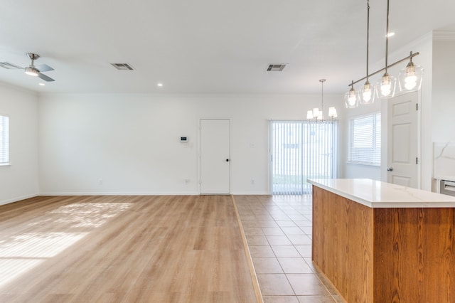 11761 Jelicoe Dr, Houston, TX 77047 - kitchen featuring a chandelier, light countertops, open floor plan, ceiling fan, and ornamental molding