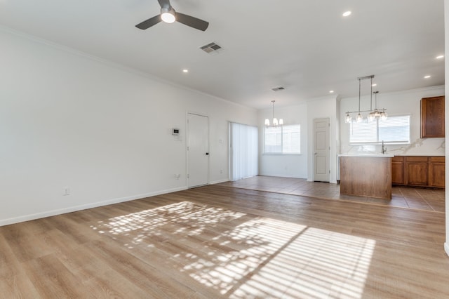 11761 Jelicoe Dr, Houston, TX 77047 - unfurnished living room featuring a chandelier, ceiling fan, crown molding, light wood finished floors, and recessed lighting