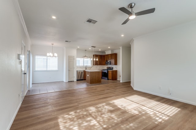 11761 Jelicoe Dr, Houston, TX 77047 - unfurnished living room with a chandelier, ornamental molding, light wood-type flooring, ceiling fan, and baseboards