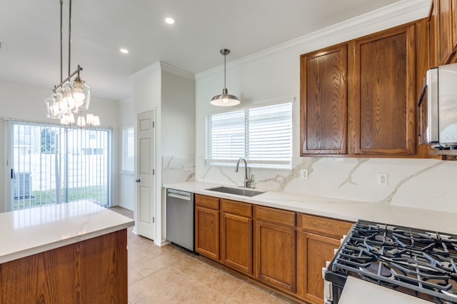 11761 Jelicoe Dr, Houston, TX 77047 - kitchen featuring appliances with stainless steel finishes, a sink, crown molding, brown cabinetry, and decorative light fixtures