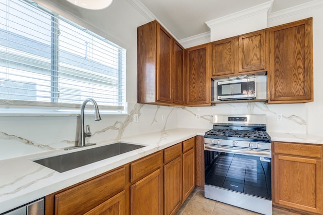 11761 Jelicoe Dr, Houston, TX 77047 - kitchen with appliances with stainless steel finishes, a sink, crown molding, light stone countertops, and brown cabinetry