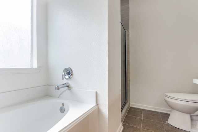 11761 Jelicoe Dr, Houston, TX 77047 - full bathroom featuring tile patterned floors, a garden tub, toilet, and an enclosed shower