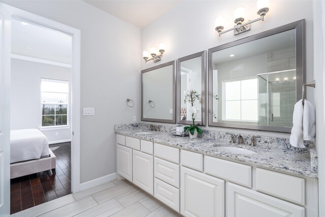 831 Dunleigh Meadows Ln, Houston, TX 77055 - ensuite bathroom featuring baseboards, a shower stall, and double vanity