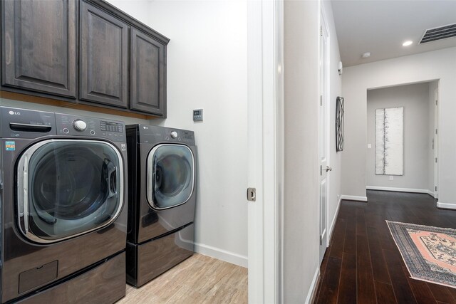 831 Dunleigh Meadows Ln, Houston, TX 77055 - clothes washing area featuring washing machine and clothes dryer, cabinet space, baseboards, wood finished floors, and recessed lighting