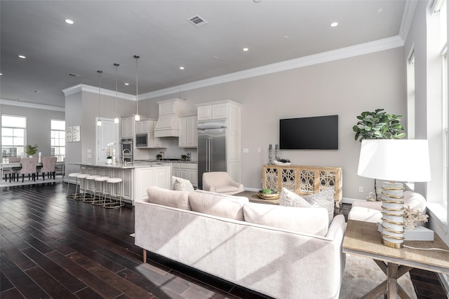 831 Dunleigh Meadows Ln, Houston, TX 77055 - living room with dark wood-style flooring, crown molding, baseboards, and recessed lighting