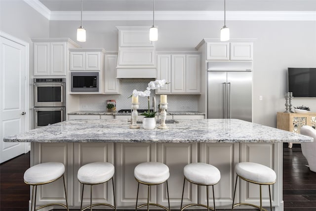 831 Dunleigh Meadows Ln, Houston, TX 77055 - kitchen with built in appliances, dark wood-style floors, ornamental molding, decorative backsplash, and white cabinetry