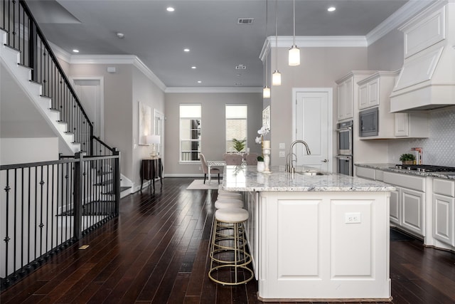 831 Dunleigh Meadows Ln, Houston, TX 77055 - kitchen with a sink, dark wood-type flooring, light stone counters, white cabinets, and recessed lighting