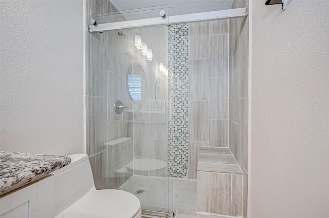 bathroom with toilet, a stall shower, and a textured wall