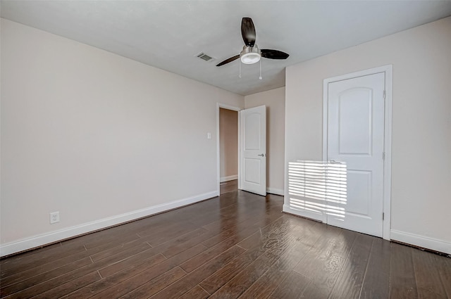 unfurnished bedroom with baseboards, dark wood finished floors, and ceiling fan