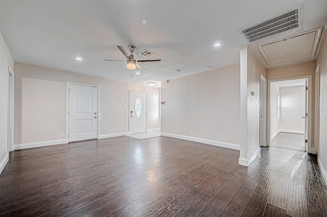 unfurnished living room featuring attic access, dark wood-type flooring, baseboards, a ceiling fan, and recessed lighting