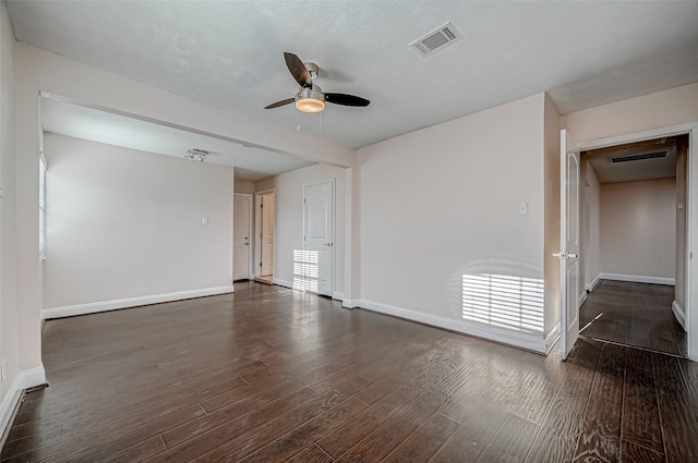 unfurnished room featuring a ceiling fan, baseboards, and wood finished floors