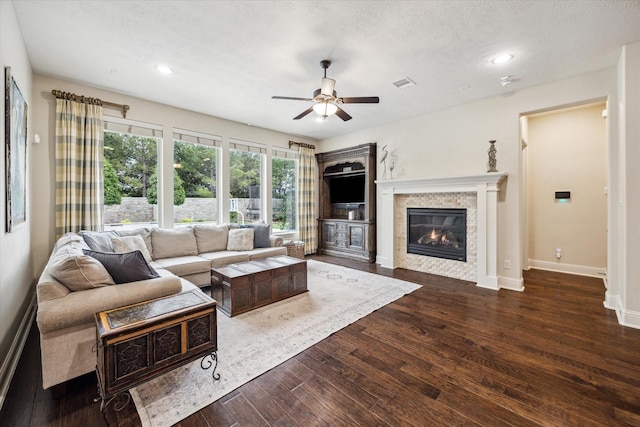 5119 Kendalia Cloud Ln, Fulshear, TX 77441 - living area featuring ceiling fan, a tiled fireplace, dark wood finished floors, recessed lighting, and baseboards