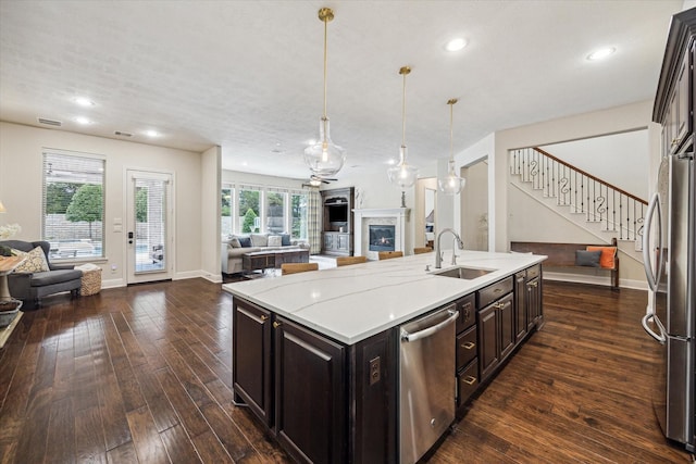 5119 Kendalia Cloud Ln, Fulshear, TX 77441 - kitchen with open floor plan, a sink, appliances with stainless steel finishes, dark wood-style flooring, and a center island with sink