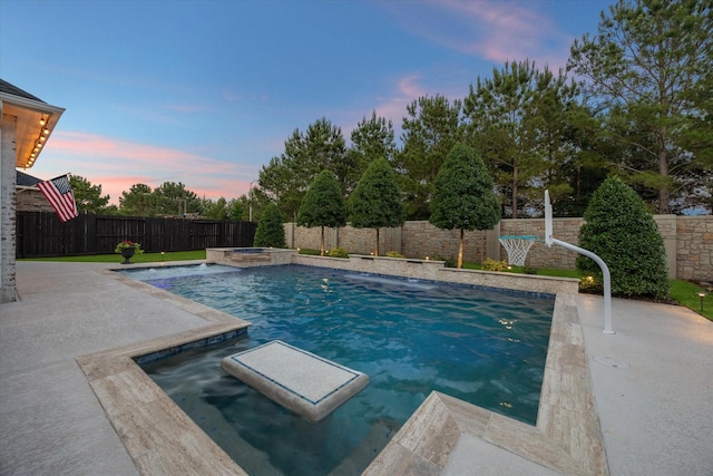 5119 Kendalia Cloud Ln, Fulshear, TX 77441 - pool at dusk with a fenced backyard, an in-ground hot tub, and a patio