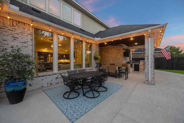 5119 Kendalia Cloud Ln, Fulshear, TX 77441 - patio terrace at dusk featuring a patio area and outdoor lounge area