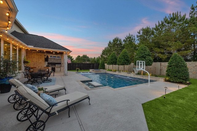 5119 Kendalia Cloud Ln, Fulshear, TX 77441 - pool at dusk featuring a patio, a fenced backyard, and a pool with connected hot tub