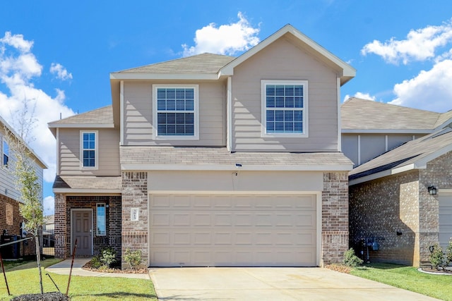 3815 W Alessano Ln, Katy, TX 77493 - view of front facade featuring roof with shingles, driveway, brick siding, and an attached garage