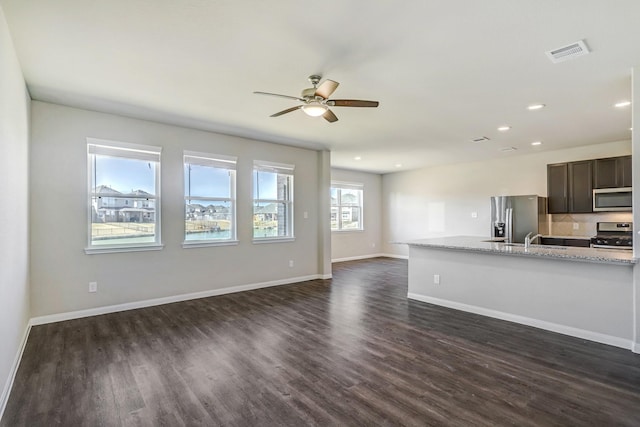 3815 W Alessano Ln, Katy, TX 77493 - unfurnished living room with dark wood-type flooring, a ceiling fan, a sink, recessed lighting, and baseboards