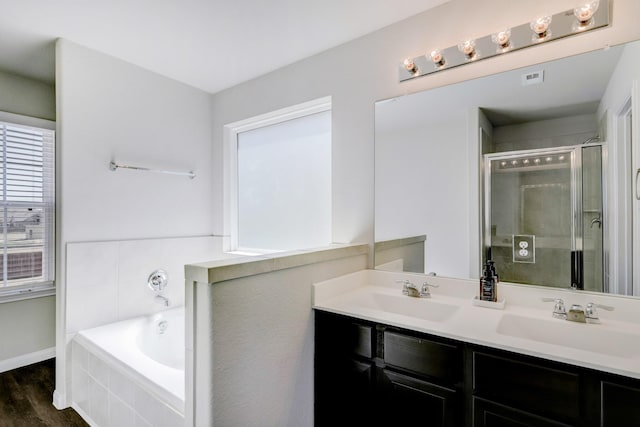 3815 W Alessano Ln, Katy, TX 77493 - bathroom with a stall shower, baseboards, double vanity, a garden tub, and wood finished floors