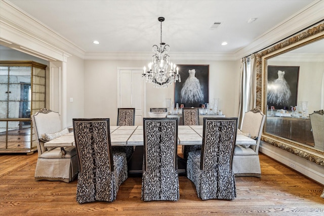 5602 Indian Cir, Houston, TX 77056 - dining area featuring a chandelier, wood finished floors, crown molding, and recessed lighting