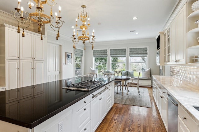 5602 Indian Cir, Houston, TX 77056 - kitchen featuring crown molding, a chandelier, appliances with stainless steel finishes, open shelves, and wood finished floors