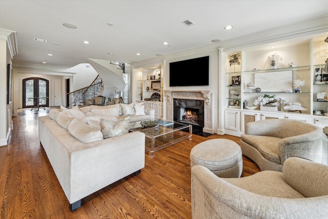 5602 Indian Cir, Houston, TX 77056 - living area featuring crown molding, stairway, wood finished floors, a fireplace with flush hearth, and recessed lighting