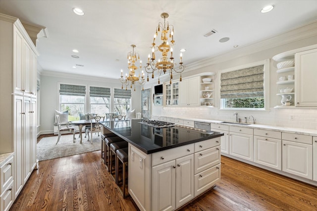 5602 Indian Cir, Houston, TX 77056 - kitchen featuring open shelves, appliances with stainless steel finishes, a kitchen island, a chandelier, and white cabinetry