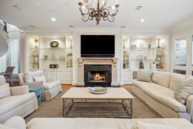 5602 Indian Cir, Houston, TX 77056 - living room with crown molding, a chandelier, light wood-style flooring, a fireplace with flush hearth, and built in shelves